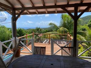 a view from the deck of a house at LE DIAMANT Charmante Villa pour la famille ou entre amis SPA et Piscine in Le Diamant +21 photos