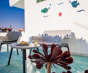 a room with a table and chairs and a plant at Palazzo De Gregorio Apartment Napoli in SantʼAntonio Abate