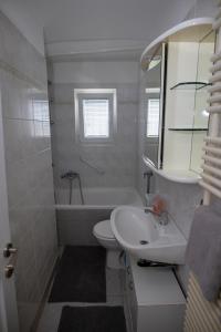 a bathroom with a sink and a toilet and a tub at Kuća za odmor Martin in Sveti Martin na Muri