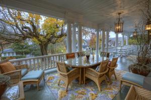 a screened porch with a table and chairs at Bluefield Inn, a Select Registry Propery in Bluefield