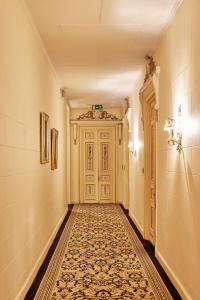 a hallway with a door and a tile floor at Le Metropole Luxury Heritage Hotel Since 1902 by Paradise Inn Group in Alexandria