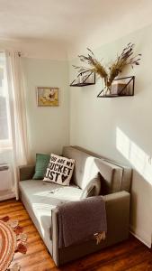 a living room with a couch and a chair at Pils Parka Apartamenti in Kuldīga