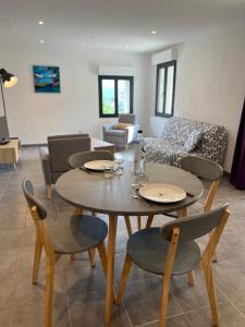 a living room with two tables and chairs and a couch at Maison Purrussoni in Levie