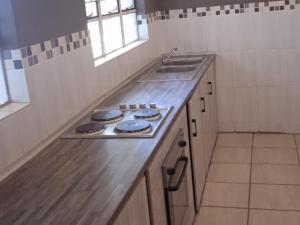 a kitchen with a sink and a counter top at Kaste guesthouse Tzaneen in Tzaneen