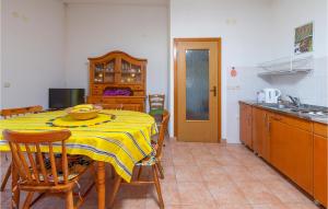 a kitchen with a table with a yellow table cloth at Apartmen Valkanela Vi in Vrsar