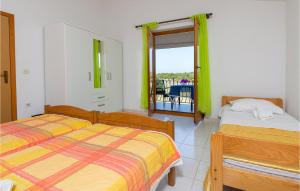 a bedroom with two beds and a balcony at Apartmen Valkanela Vi in Vrsar