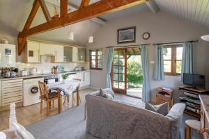 a kitchen and living room with a couch and a table at Beautiful Cottage With Stunning Views in Box in Box