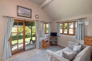 a living room with a couch and a tv at Beautiful Cottage With Stunning Views in Box in Box