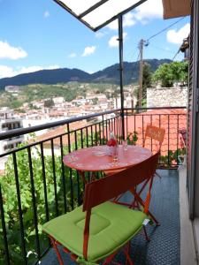 una mesa y sillas en un balcón con vistas en Η Φωλιτσα en Karpenision