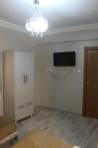 a living room with a flat screen tv on the wall at KONAK HOTEL 2 in Kars