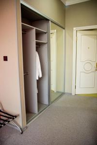 a walk in closet with a mirror and a door at Boutique Spa Casino Hotel Lybid Plaza in Khmelnytskyi