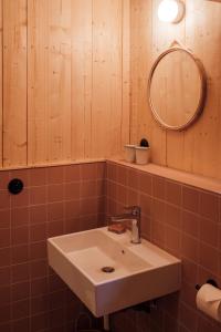 La salle de bains est pourvue d'un lavabo et d'un miroir. dans l'établissement Youza ecolodge, à La Couture-Boussey