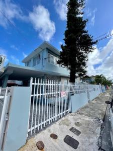 a white fence in front of a house at Casa Magdalena in San Juan