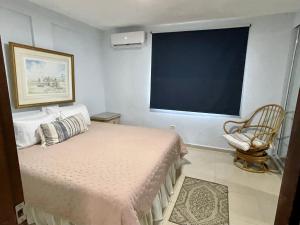a bedroom with a bed and a large window at Casa Magdalena in San Juan