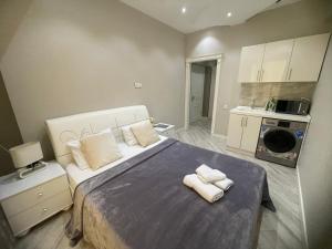 1 dormitorio con 1 cama grande y toallas. en Luxe Azure Apartment, en Baku