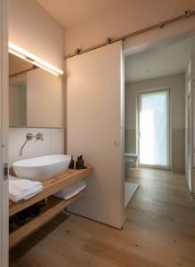 a bathroom with a white sink and a mirror at Borgo Roggeri - Country House nelle Langhe in La Morra