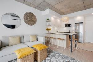 ein Wohnzimmer mit einem Sofa und einer Küche in der Unterkunft Initial / Yogi+ Parking / Centre-Ville de Québec in Québec