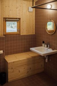 een badkamer met een wastafel en een houten bad bij Youza ecolodge in La Couture-Boussey