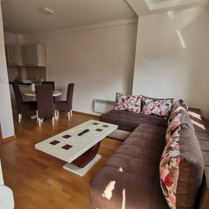 a living room with a couch and a table at Apartman Lea & parking u garaži in Soko Banja