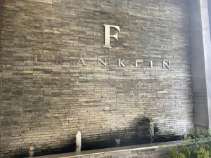 a sign on the side of a brick wall at Apartment on 8th in Johannesburg