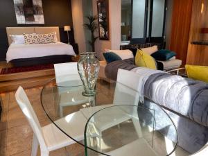 a living room with a couch and a glass table at Apartment on 8th in Johannesburg
