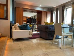 a living room with a couch and a table at Apartment on 8th in Johannesburg