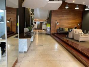 a lobby with couches and chairs in a building at Apartment on 8th in Johannesburg