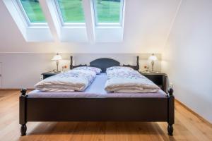 a bedroom with a black bed with two night stands at Alpen Living - 2 Stock in Cadipietra