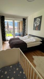 a bedroom with two beds and a balcony at Ferienwohnung Karasek Deluxe in Sattendorf