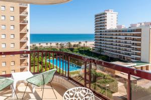 a balcony with a view of a pool and the ocean at AG SALINAS in Playa de Gandia