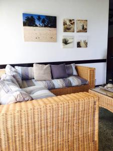 a living room with a couch and a wicker sofa at Villa Karel Mauritius Beach house in Riambel