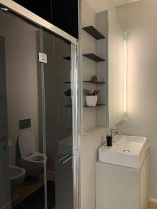 ein Bad mit einer Dusche, einem Waschbecken und einem WC in der Unterkunft SKY in Lugano