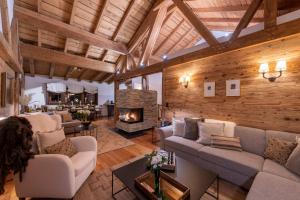 a living room with couches and a fireplace at Kikombe Lodge in Sankt Anton am Arlberg