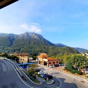 a street in a town with a mountain in the background at Appartamento Pizzo di Parlasco - Your Mountain Holiday in Taceno