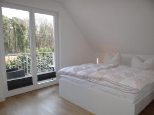 Katil atau katil-katil dalam bilik di Ferienanlage Haus hinter den Dünen App 10 DG 2
