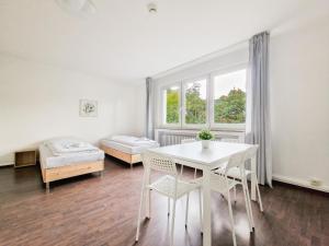 Habitación con mesa, sillas y cama en RAJ Living - 1 or 3 Room Apartments - 30 Min Messe DUS, en Duisburg