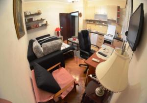 a small living room with a couch and a table at Apartment Heart of Podgorica in Podgorica
