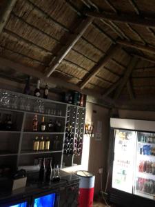 a bar with a lot of wine bottles on the wall at LEHAE BNB in Mbabat