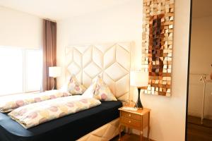 a bedroom with a bed with a large window at XuBa ApartmentRooms Messe Wien Prater in Vienna