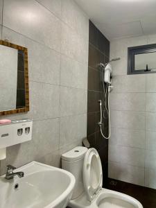 a bathroom with a toilet and a sink at Meritus Studio Holiday (Perai) in Perai
