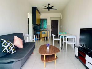 a living room with a couch and a table at Meritus Studio Holiday (Perai) in Perai