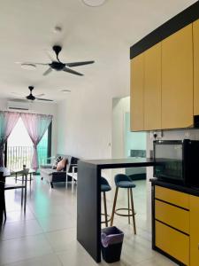 a kitchen and living room with a ceiling fan at Meritus Studio Holiday (Perai) in Perai