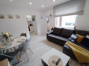 a living room with a couch and a table at Mieszkanie Reda in Reda
