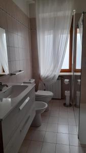 a white bathroom with a toilet and a sink at Casa Germana in Invorio Inferiore