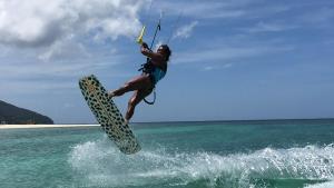 a person on a board in the water at Wind Rider's Inn in Boracay