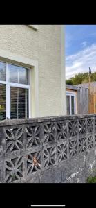 a black fence in front of a house at Pen-Y-Bryn Annex in Brynmenyn