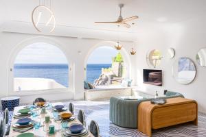 a living room with a table and a view of the ocean at Acquachiara Seaside Luxury Villa in Amalfi Coast in Maiori