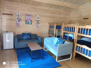 a living room with bunk beds and a couch at Camping Playa La Bota in Punta Umbría