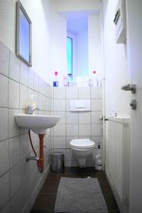 a bathroom with a sink and a toilet at Goldstadt Ferienwohnung in Pforzheim