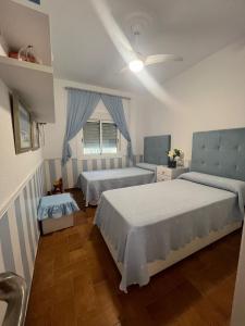 a bedroom with two beds and a window at Cortijo Indalo in Pechina
